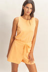 Woman wearing a yellow Drawstring Waist Sleeveless Romper on a plain background