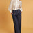 model wearing denim blue High Waisted Wide Leg Dress Pants with a white button down blouse